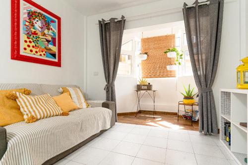 a living room with a couch and a window at YOLO House - Corralejo in Corralejo