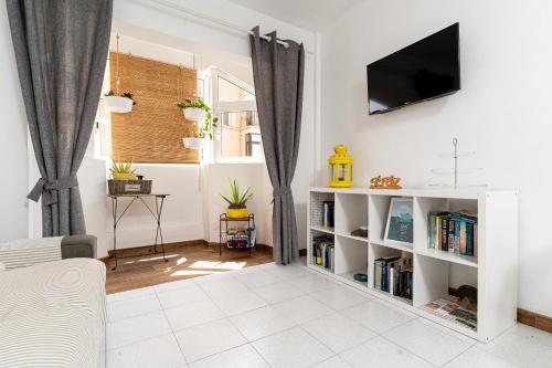 a living room with a tv on a wall at YOLO House - Corralejo in Corralejo