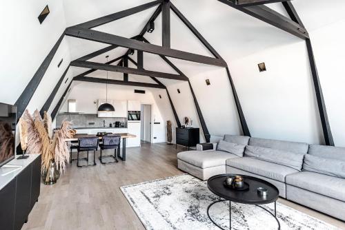 a living room with a couch and a table at Sack-Time fashion boutique hotel 6 & 7 in Zandvoort