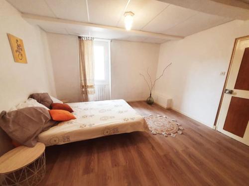 a bedroom with a bed in the middle of a room at La Galine, Maison de village medieval in Lunas