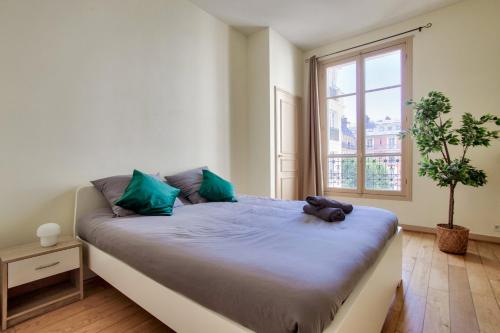 a bedroom with a large bed with a window at 2 Bedrooms Tour Eiffel Rapp in Paris