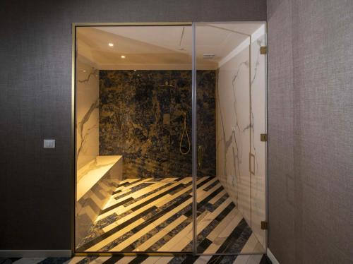 a glass elevator in a room with a staircase at Hotel Cala Moresca in Bacoli