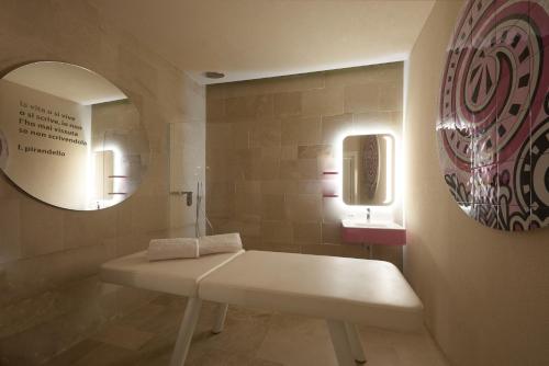 a bathroom with a white sink and a mirror at Palazzo Gatto Art Hotel & SPA - BW Premier Collection in Trapani