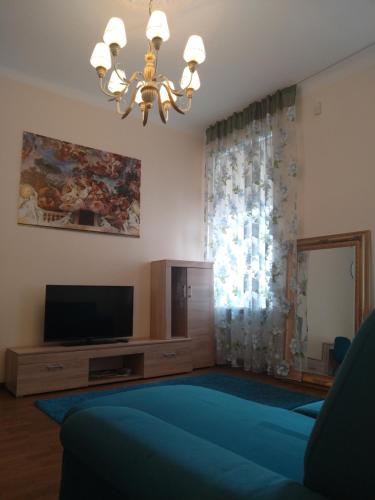 a living room with a television and a chandelier at DICTUMFACTUM RESIDENCE 1BedRoom in Tallinn
