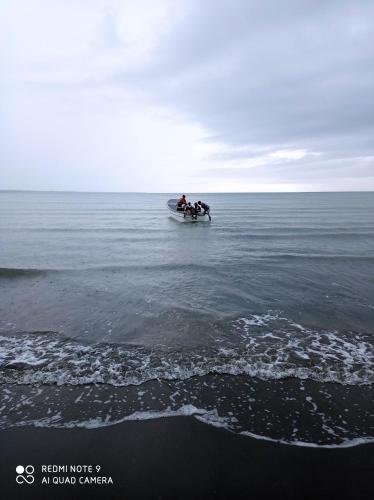 a group of people in a boat in the ocean at HOSTAL BELLEZA TROPICAL in Moñitos