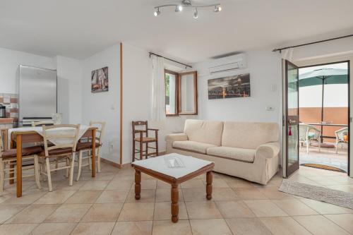 a living room with a couch and a table at Casa Bice 2 in Golfo Aranci