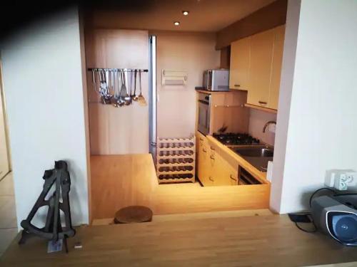 a kitchen with a camera on a tripod in a room at Appartement moderne de 94 m² 2 ch. sur la digue in Nieuwpoort