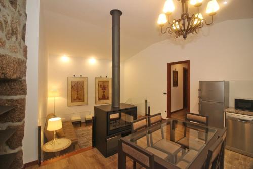 a kitchen with a stove in a room at Casa da Lameira II by Gerês Casas in Geres
