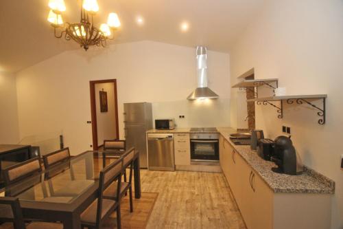 a kitchen and dining room with a dining table at Casa da Lameira II by Gerês Casas in Geres