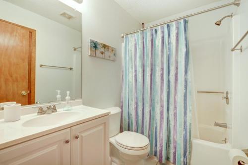 a bathroom with a toilet sink and a shower curtain at Pooler Travelers Retreat IV - Entire House - in Savannah