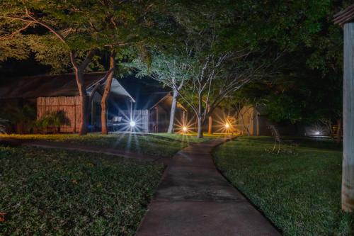 a driveway leading to a house at night at Crocodile Bridge Safari Lodge in Komatipoort