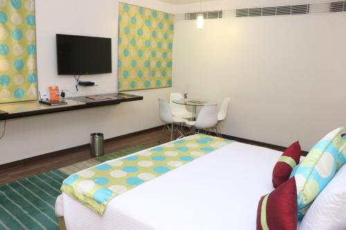a hotel room with a bed and a tv at Fortune Inn Sree Kanya, Visakhapatnam - Member ITC Hotels' Group in Visakhapatnam