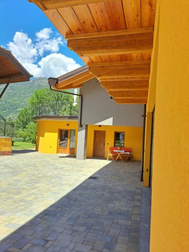 a patio of a house with a wooden roof at La maison de Chantal in Fenis