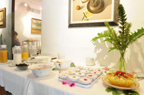 a table with a white table cloth with food on it at Hotel Rural Biniarroca - Adults Only in Sant Lluis