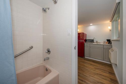 a bathroom with a tub and a red refrigerator at Silver Ridge Lodge in Salida