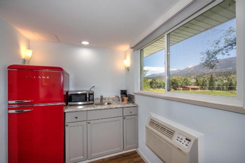 a red refrigerator in a kitchen with a window at Silver Ridge Lodge in Salida