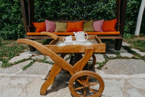 a wooden wagon with a couch and a wheel at Holiday Home Bonum in Bihać