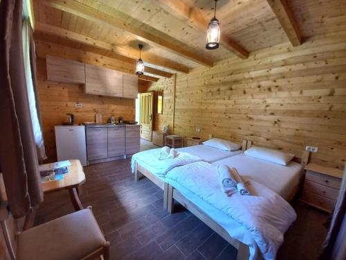 a bedroom with a large bed in a wooden room at Vila Montana in Dobrilovina