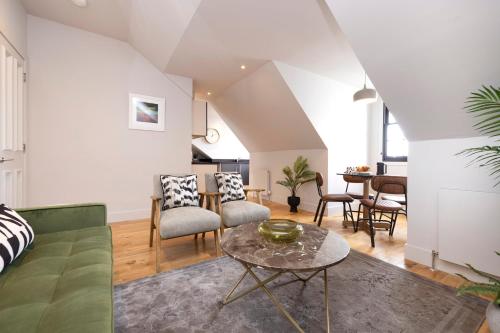 a living room with a couch and a table at JOIVY Luxury Flat near Edinburgh Castle in Edinburgh