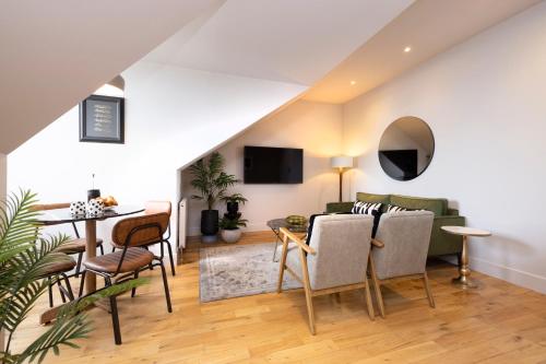 a living room with a couch and a table at JOIVY Luxury Flat near Edinburgh Castle in Edinburgh