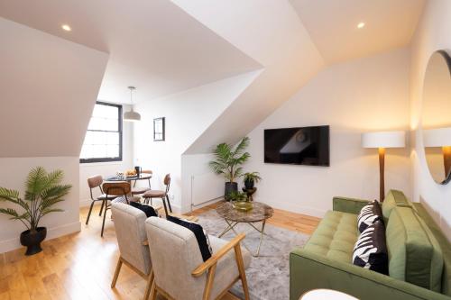 a living room with a couch and a table at JOIVY Luxury Flat near Edinburgh Castle in Edinburgh