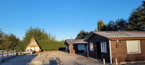 a dog is standing in front of a house at Cabañas IBY y KIARA para 4 en Puerto Varas in Puerto Varas