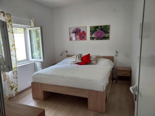 a bedroom with a bed with two pillows on it at Beach House in Betina