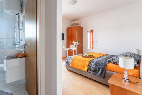 A bed or beds in a room at Apartments Dobrila