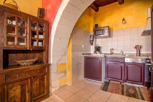 a kitchen with purple cabinets and a sink at Samonas - Red villa Fliskouni in Chania