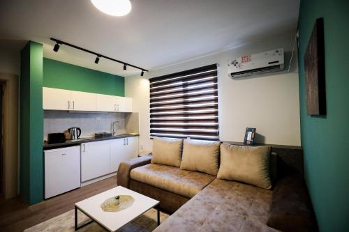 a living room with a couch and a table at Domaćin Komšijska Gostiona in Zrenjanin