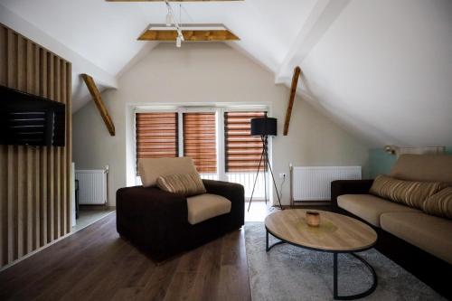 a living room with a couch and a table at Domaćin Komšijska Gostiona in Zrenjanin