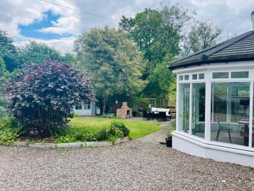 a house with a conservatory and a garden at 5 bedrooms sleeps 10-12 free wifi & parking garden in Lundin Links