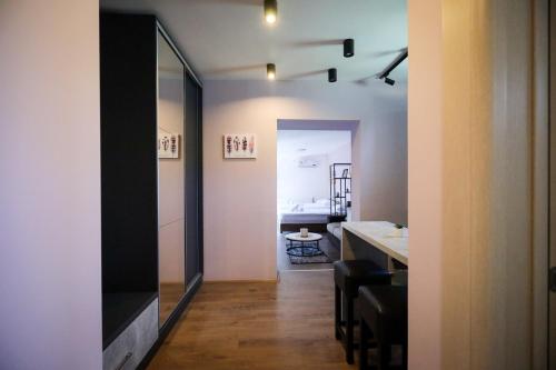 a room with a mirror and a dining room at Domaćin Komšijska Gostiona in Zrenjanin