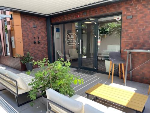 a patio with a bench and a table at Caro Apartments & Rooms in Varna City