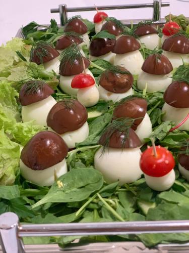 a tray of appetizers with strawberries and lettuce at Penzión Turista in Banská Štiavnica