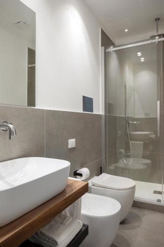 a bathroom with a sink and a toilet and a shower at Mori's Rooms in Palermo