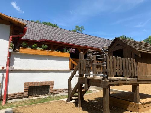 a wooden bench in front of a building at Penzión Turista in Banská Štiavnica