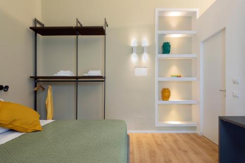 a bedroom with shelves and a bed in a room at Mori's Rooms in Palermo
