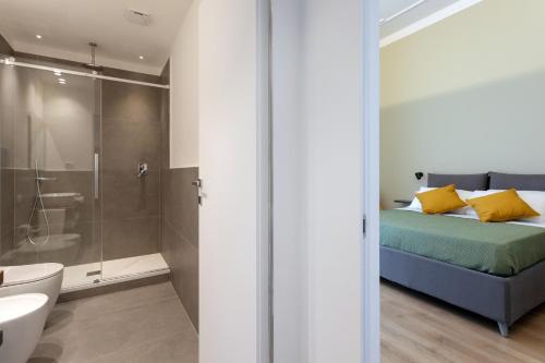 a bathroom with a bed and a shower and a sink at Mori's Rooms in Palermo