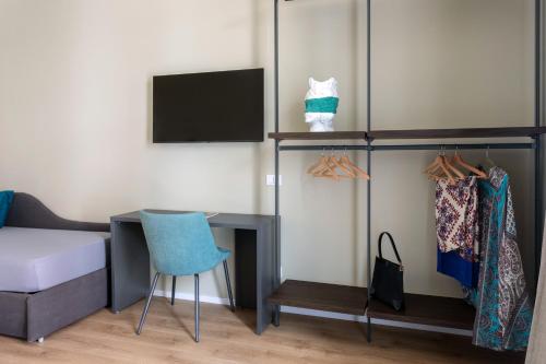 a bedroom with a desk and a bed and a tv at Mori's Rooms in Palermo