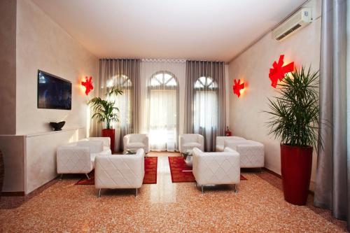 a waiting room with white chairs and redidents at Momi's Hotel in Cavarzere