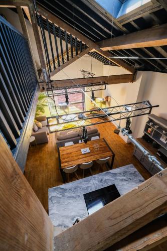 an overhead view of a living room with a wooden table at The Eden Warehouse - Gold Apartment, sleeps 6 in Southport