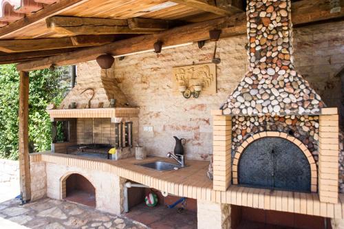 an outdoor kitchen with a stove and an oven at Amalia Apartments in Stoupa