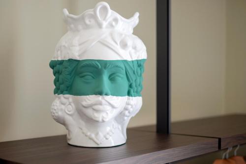 a statue of a head with a crown on a shelf at Mori's Rooms in Palermo