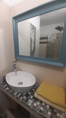 a bathroom with a sink and a mirror at Global Trip Apartament in Tychy