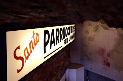 a sign for a parking garage on a brick wall at LANCETTI Stylish Loft - hosted by Sweetstay in Milan