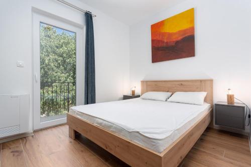 Ένα ή περισσότερα κρεβάτια σε δωμάτιο στο Small village apartman
