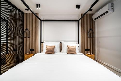 a bedroom with a large white bed with two pillows at Blanche Cliff Apartments in Sveti Stefan