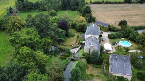 an aerial view of a house and a river at Les roulottes du Moulin de Palet 