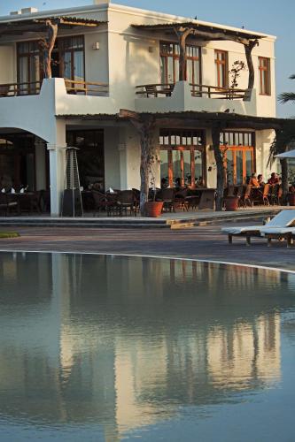 a building with a pool of water in front of it at La Hacienda Bahia Paracas in Paracas